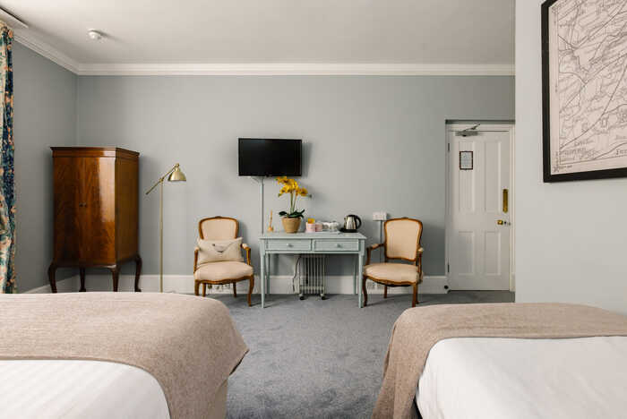 Spacious Family Suite with multiple beds and cozy seating area at The Abbey London